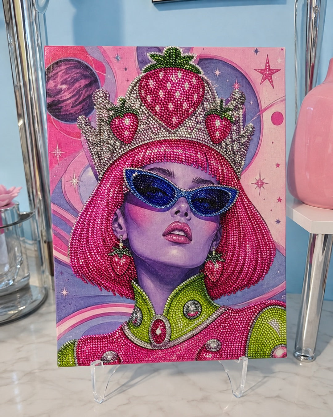 Pink-haired woman with blue sunglasses and a strawberry crown in pearl-and-gem DIY artwork